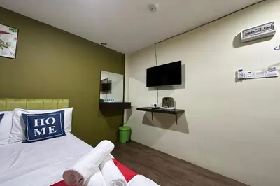 a bedroom with a bed and a tv on the wall at Hotel MSP Bukit Bintang in Kuala Lumpur
