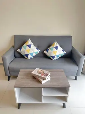 a living room with a couch and a coffee table at Cozy Family Suite Kepong DesaPark MontKiara Publika Mitec in Kuala Lumpur