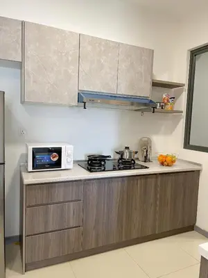 a kitchen with a stove and a microwave at Cozy Family Suite Kepong DesaPark MontKiara Publika Mitec in Kuala Lumpur