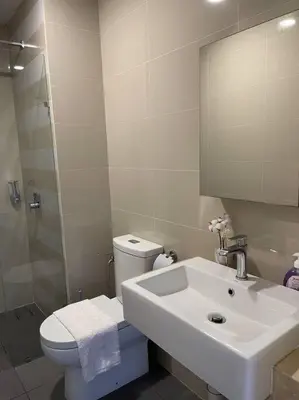 a bathroom with a sink and a toilet and a mirror at Cozy Family Suite Kepong DesaPark MontKiara Publika Mitec in Kuala Lumpur