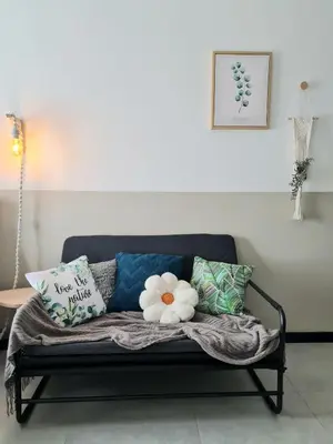 a black couch with pillows on it in a living room at Cozy 2R2B near Gleneagles @ Embassy Row KLCC in Kuala Lumpur