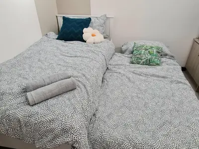 a bed with a comforter and a stuffed animal on it at Cozy 2R2B near Gleneagles @ Embassy Row KLCC in Kuala Lumpur