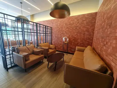 a waiting room with couches and a brick wall at Cozy 2R2B near Gleneagles @ Embassy Row KLCC in Kuala Lumpur