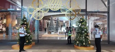 two police officers standing in a mall with christmas trees at Plaza Berjaya Apt Bukit Bintang With Foosball in Kuala Lumpur