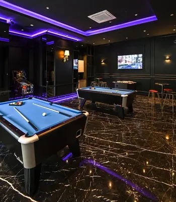 a billiard room with two pool tables and a screen at Star Residence Apartment with High Kuala Lumpur view in Kuala Lumpur