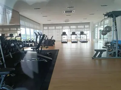 a gym with several treadmills and exercise bikes at Muji Style, Inspirasi Residences Mont Kiara in Kuala Lumpur