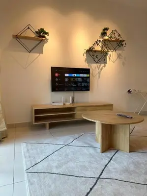 a living room with a flat screen tv on a wall at Muji Style, Inspirasi Residences Mont Kiara in Kuala Lumpur