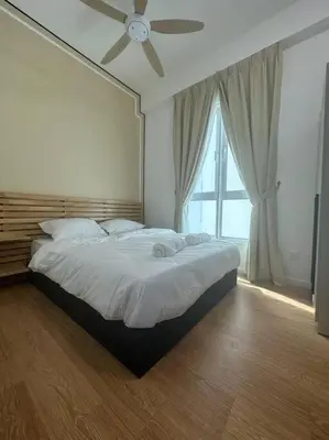 a bedroom with a large bed with a ceiling fan at Inspirasi Residences Mont Kiara muji house in Kuala Lumpur