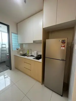 a kitchen with a refrigerator and white cabinets at Inspirasi Residences Mont Kiara muji house in Kuala Lumpur