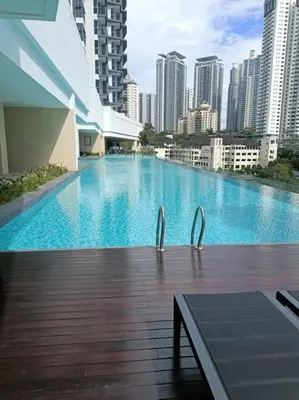 a large swimming pool in a city with tall buildings at Inspirasi Residences Mont Kiara muji house in Kuala Lumpur