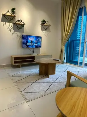 a living room with a flat screen tv on a wall at Inspirasi Residences Mont Kiara muji house in Kuala Lumpur