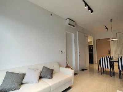 a living room with a white couch and a dining room at The Axon Bukit Bintang by SMOVF BNB in Kuala Lumpur