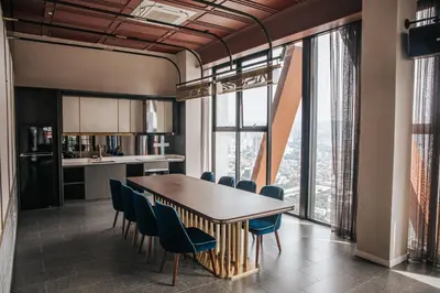 a kitchen and dining room with a table and chairs at Scarletz Leisure Suites KLCC in Kuala Lumpur