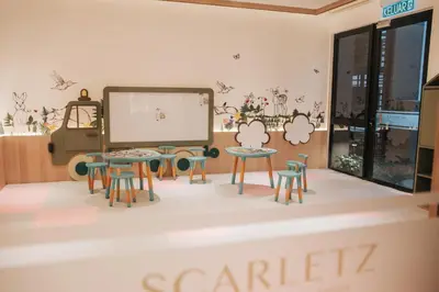 a room with tables and chairs and a large screen at Scarletz Leisure Suites KLCC in Kuala Lumpur