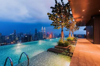 a swimming pool with a city skyline in the background at Expressionz Leisure Suites KLCC in Kuala Lumpur