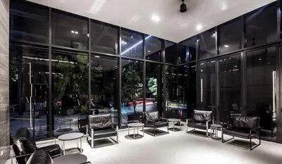 a room with chairs and tables in a building at Expressionz Leisure Suites KLCC in Kuala Lumpur