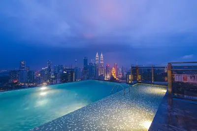 a swimming pool on top of a building with a city skyline at Expressionz Leisure Suites KLCC in Kuala Lumpur