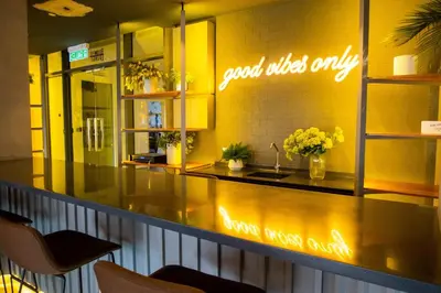 a restaurant with a counter with a sign on the wall at Ceylonz Leisure Suites KLCC Bukit Bintang in Kuala Lumpur