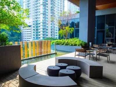 a patio with chairs and tables in a building at Ceylonz Leisure Suites KLCC Bukit Bintang in Kuala Lumpur