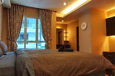 a bedroom with a bed with a cat laying on it at KLCC Luxurious 2 Floors Homestay 5BR for 15pax in Kuala Lumpur