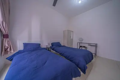 two beds in a room with blue pillows at Zen 3-bedroom w pool 6 pax - Semarak in Kuala Lumpur
