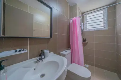 a bathroom with a sink and a toilet and a mirror at Zen 3-bedroom w pool 6 pax - Semarak in Kuala Lumpur
