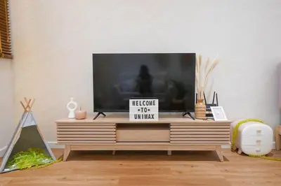 a living room with a television on a tv stand at Chambers Suite Studio KLCC PWTC by Unimax in Kuala Lumpur