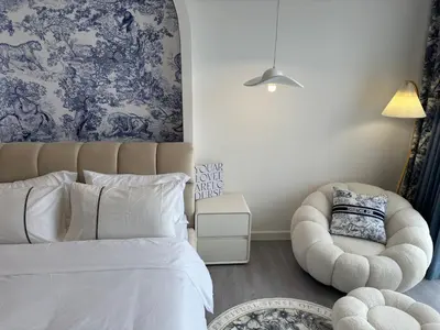 a bedroom with a white bed and a chair at Chambers Suite Studio KLCC PWTC by Unimax in Kuala Lumpur