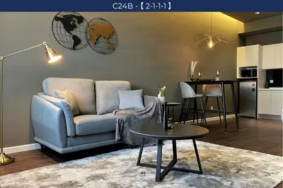 a living room with a couch and a table at Chambers Suite Studio KLCC PWTC by Unimax in Kuala Lumpur