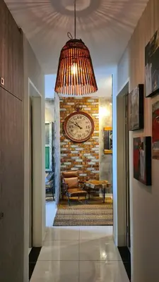 a hallway with a large clock on a brick wall at Bricks & Beds Suite @ Legasi Kg Bahru in Kuala Lumpur