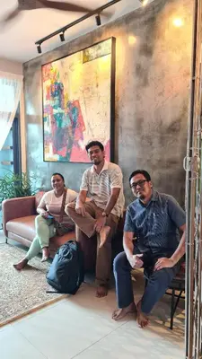 a group of three men sitting in a living room at Bricks & Beds Suite @ Legasi Kg Bahru in Kuala Lumpur