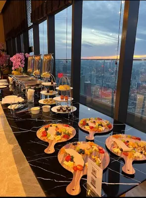 a buffet of pizzas on a table in a building at Star residance KLCC-Two bedroom Apartment in Kuala Lumpur
