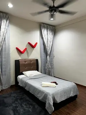 a bedroom with a bed with red shoes on the wall at Zetapark, The Loft in Kuala Lumpur
