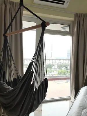 a hammock hanging in front of a window at Ampang Hilir KL City Boutique Residence in Kuala Lumpur