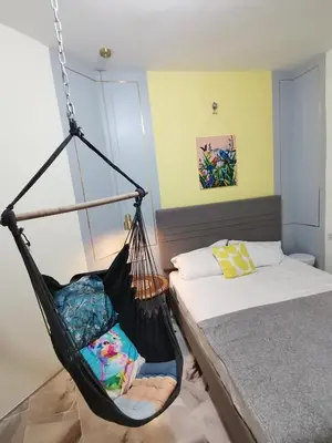 a black swing in a bedroom with a bed at Ampang Hilir KL City Boutique Residence in Kuala Lumpur