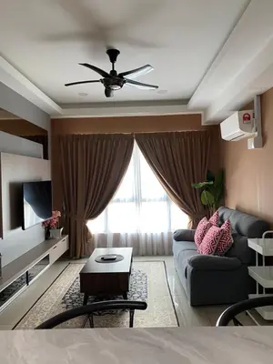 a living room with a couch and a ceiling fan at M Centura Sentul in Kuala Lumpur