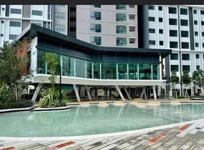a building with a swimming pool in front of a building at M Centura Sentul in Kuala Lumpur