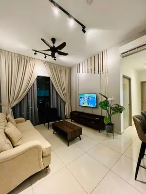 a living room with a couch and a flat screen tv at The Harmony at Astoria Ampang - Mountain View in Kuala Lumpur