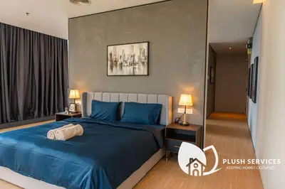 a bedroom with a blue bed and two night stands at Bangsar Trade Centre in Kuala Lumpur