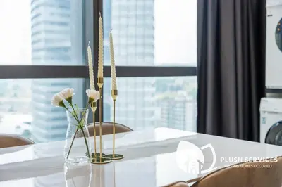 a white table with a vase with flowers in it at Bangsar Trade Centre in Kuala Lumpur