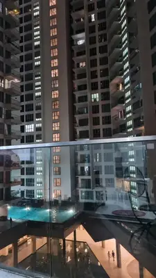 a view of a city at night with tall buildings at Hostel At Regalia Sky Pool in Kuala Lumpur