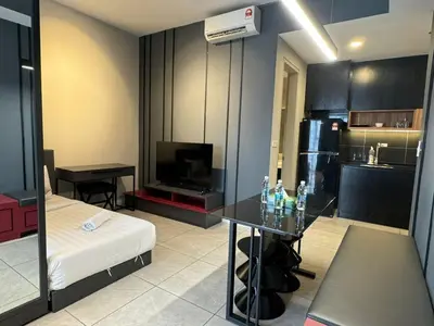 a living room with a table and a kitchen at AXON SUITE aT BUKIT BINTANG KL near Pavillion in Kuala Lumpur