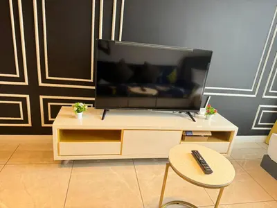 a living room with a television on a table with a chair at AXON SUITE aT BUKIT BINTANG KL near Pavillion in Kuala Lumpur