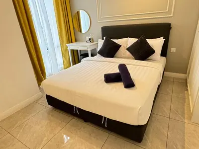 a bedroom with a bed with two towels on it at AXON SUITE aT BUKIT BINTANG KL near Pavillion in Kuala Lumpur