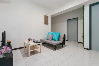 a living room with a chair and a table at Plaza Berjaya Apt Bukit Bintang With 3 Bedroom in Kuala Lumpur