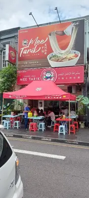 a restaurant with tables and chairs in front of it at Plaza Berjaya Apt Bukit Bintang With 3 Bedroom in Kuala Lumpur