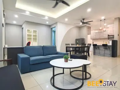 a living room with a blue couch and a table at Rafflesia Condominium Sentul by Beestay in Kuala Lumpur