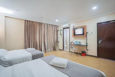 a hotel room with two beds and a flat screen tv at Hotel 28 Titiwangsa in Kuala Lumpur