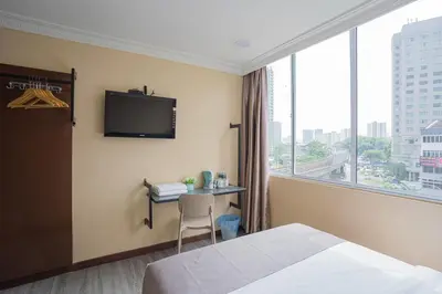 a hotel room with a bed and a desk and a window at Hotel 28 Titiwangsa in Kuala Lumpur