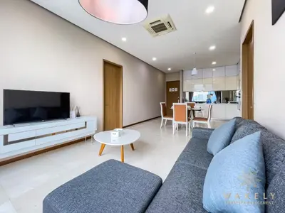 a living room with a couch and a tv at Soho Suites KLCC by Wakely Kuala Lumpur in Kuala Lumpur